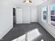 Well-lit bedroom with grey carpet and two windows at 83 Valleyfield Dr, Clayton, NC 27527