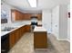 Kitchen with island, wood cabinets, and stainless steel appliances at 83 Valleyfield Dr, Clayton, NC 27527