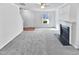 Spacious living room featuring gray carpeting and a fireplace at 83 Valleyfield Dr, Clayton, NC 27527