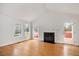 Gathering room with hardwood floors, fireplace, and access to deck at 908 Glen Eden Dr, Raleigh, NC 27612