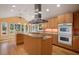 Kitchen with island, stainless steel appliances, and hardwood floors at 908 Glen Eden Dr, Raleigh, NC 27612