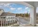 Scenic balcony view overlooking nearby houses and trees, framed by white pillars and railings at 10310 Sablewood Dr # 108, Raleigh, NC 27617