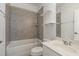 Bathroom features a gray tiled shower and tub combination, a toilet, and a vanity at 10310 Sablewood Dr # 108, Raleigh, NC 27617
