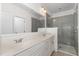 Modern bathroom featuring double sinks, a large mirror, and a glass-enclosed shower at 10310 Sablewood Dr # 108, Raleigh, NC 27617