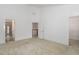 Spacious bedroom with neutral carpet, white walls, and two entrances to a closet and bathroom at 10310 Sablewood Dr # 108, Raleigh, NC 27617