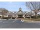 Community clubhouse featuring red shutters, columns, tan siding and professional landscaping at 10310 Sablewood Dr # 108, Raleigh, NC 27617