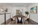 Elegant dining room featuring a stylish dark wood table, comfortable seating for six, and modern artwork at 10310 Sablewood Dr # 108, Raleigh, NC 27617