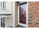 Townhouse entry with glass storm door and brick surround at 10310 Sablewood Dr # 108, Raleigh, NC 27617