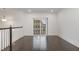Bright hallway with hardwood floors, a sliding glass door to the outside, and neutral paint at 10310 Sablewood Dr # 108, Raleigh, NC 27617