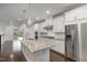 Open kitchen with stainless steel appliances and granite countertops at 10310 Sablewood Dr # 108, Raleigh, NC 27617