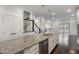Kitchen island has granite counter tops and a stainless steel dishwasher at 10310 Sablewood Dr # 108, Raleigh, NC 27617