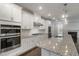 Modern kitchen featuring stainless appliances, granite counters, and ample cabinet space at 10310 Sablewood Dr # 108, Raleigh, NC 27617