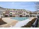 Community pool with townhomes in the background featuring brick and siding and private balconies at 10310 Sablewood Dr # 108, Raleigh, NC 27617