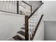 Modern staircase with dark wood railings and white balusters at 10310 Sablewood Dr # 108, Raleigh, NC 27617
