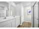 Double vanity bathroom with a large shower and linen storage at 104 Cavalier Rider Run, Wendell, NC 27591