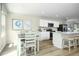 Kitchen and dining area with light wood floors and white furniture at 104 Cavalier Rider Run, Wendell, NC 27591