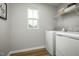 Bright laundry room with washer, dryer, and shelving at 104 Cavalier Rider Run, Wendell, NC 27591