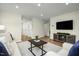 Living room with hardwood floors, neutral decor, and access to bedrooms at 104 Cavalier Rider Run, Wendell, NC 27591