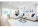 Open living room and kitchen with neutral decor and hardwood floors at 104 Cavalier Rider Run, Wendell, NC 27591