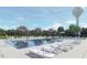 Community swimming pool with ample lounge chairs, umbrellas, and scenic views of the neighborhood at 104 Cavalier Rider Run, Wendell, NC 27591