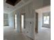 Hallway featuring multiple doorways and a window that offer natural lighting at 110 Tennyson Dr, Garner, NC 27529