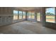 Sunlit living area featuring expansive windows and a doorway to the patio, ideal for relaxation and entertainment at 110 Tennyson Dr, Garner, NC 27529
