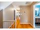 Bright hallway with hardwood floors and access to bedrooms at 1302 Apache Ln, Apex, NC 27502