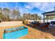 Spacious backyard with raised garden beds, patio furniture, and a covered patio at 139 Red Angus Dr, Smithfield, NC 27577