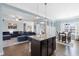 Open kitchen with island and view into living and dining areas at 139 Red Angus Dr, Smithfield, NC 27577