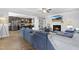 Open living room with fireplace and kitchen views. Features hardwood floors and comfortable sectional sofa at 139 Red Angus Dr, Smithfield, NC 27577