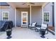 Covered patio with rocking chairs and grill at 139 Red Angus Dr, Smithfield, NC 27577