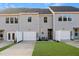 Rear view of townhouses with garage and yard at 1431 Goldsboro Ave, Sanford, NC 27330