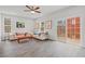 Living room with hardwood floors, large windows, and access to deck at 1514 Excelsior Grand Ave, Durham, NC 27713