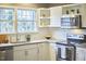 Modern kitchen features stainless steel appliances and white shaker cabinets at 1606 Rosetta Dr, Durham, NC 27701