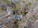 Aerial view showing home's setting in a wooded neighborhood at 1800 Deer Fern Dr, Raleigh, NC 27606