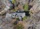 Aerial view of house and surrounding wooded area at 1800 Deer Fern Dr, Raleigh, NC 27606