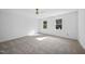 Spacious bedroom with neutral carpeting, ceiling fan, and ample natural light at 1800 Deer Fern Dr, Raleigh, NC 27606