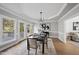 Bright dining room with hardwood floors, chandelier, and access to deck at 1800 Deer Fern Dr, Raleigh, NC 27606