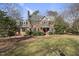 Brick two-story home with landscaped lawn and red front door at 1800 Deer Fern Dr, Raleigh, NC 27606