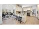Open concept kitchen with island, breakfast bar, and access to sunroom at 1800 Deer Fern Dr, Raleigh, NC 27606