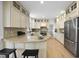 Eat-in kitchen with granite countertops, island with seating, and stainless steel appliances at 1800 Deer Fern Dr, Raleigh, NC 27606