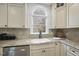 Kitchen boasts granite countertops, a farmhouse sink, and custom cabinetry at 1800 Deer Fern Dr, Raleigh, NC 27606