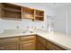Small kitchenette with wood cabinets and a sink at 1800 Deer Fern Dr, Raleigh, NC 27606