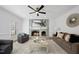 Living room with fireplace, comfy seating, and large windows at 1800 Deer Fern Dr, Raleigh, NC 27606