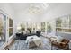 Bright sunroom with hardwood floors, comfortable seating, and abundant natural light at 1800 Deer Fern Dr, Raleigh, NC 27606