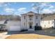 Charming two-story home with light gray siding, white trim, a front porch, and an attached garage at 187 Ashley Woods Ct, Clayton, NC 27527