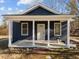 Newly renovated home featuring a charming front porch and dark blue exterior at 1917 Faucette Ave, Durham, NC 27704