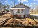 Renovated gray house with a sunroom and stairs leading to the front door at 1917 Faucette Ave, Durham, NC 27704