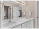 Bathroom with double vanity, mirror, and white cabinets at 2008 Joelene Dr, Rocky Mount, NC 27803