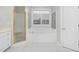 Well-lit bathroom with a separate shower and tub, complemented by white tiled flooring and neutral walls at 2008 Joelene Dr, Rocky Mount, NC 27803